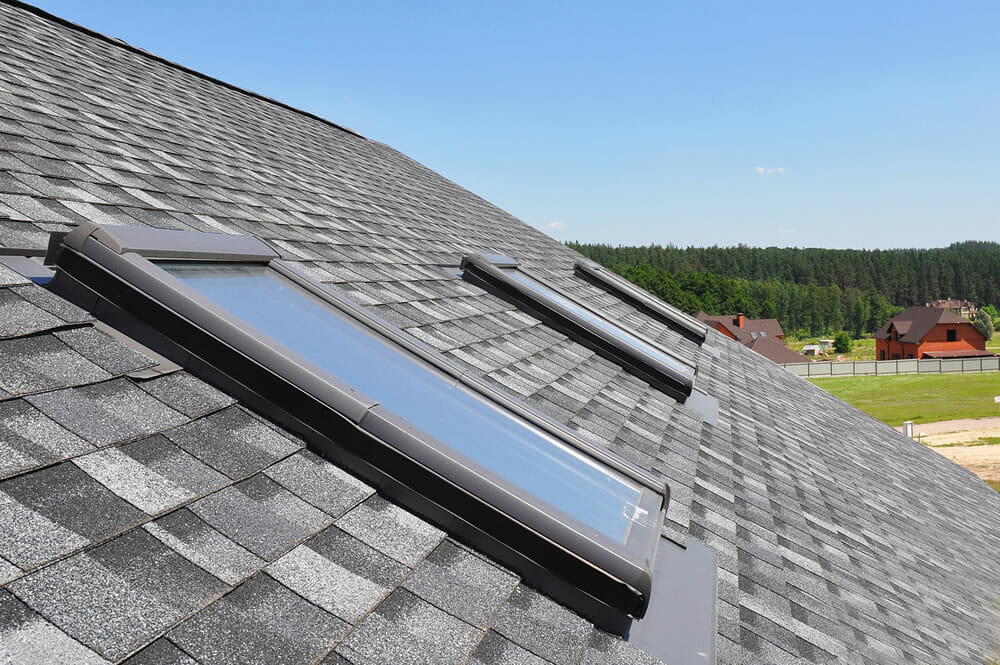 asphalt shingle roofing with skylights installed